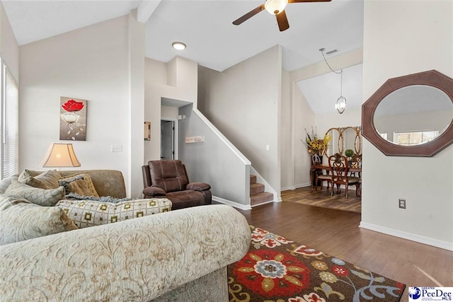 living room featuring vaulted ceiling, dark hardwood / wood-style floors, and ceiling fan