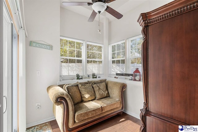 living area featuring ceiling fan and hardwood / wood-style floors