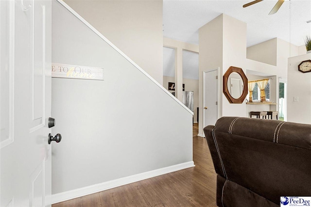 interior space with ceiling fan, dark hardwood / wood-style floors, and vaulted ceiling