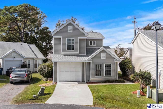 view of front property with a garage and a front lawn