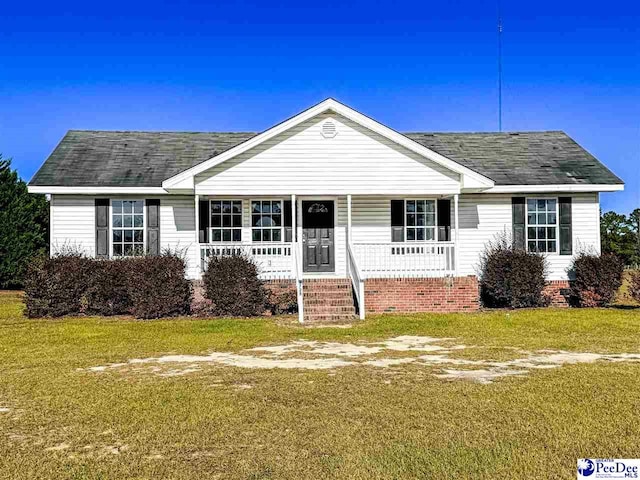 single story home with covered porch and a front lawn