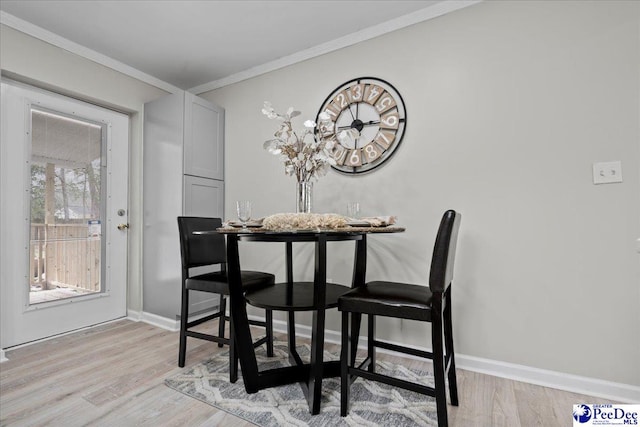 236 Wells St, Lake City, SC 29560 - dining room with baseboards, crown molding, and light wood-style floors