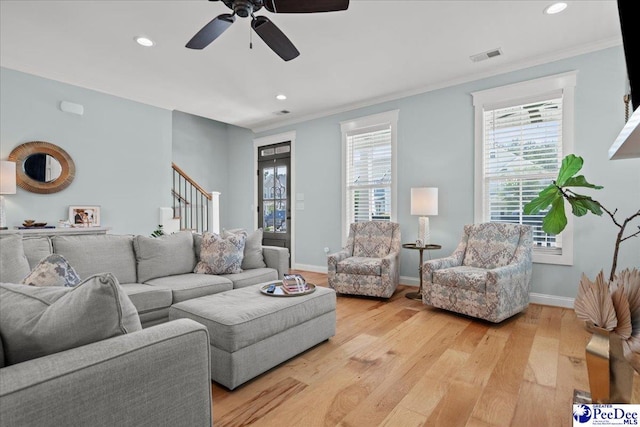 living room featuring recessed lighting, light wood-style floors, crown molding, ceiling fan, and baseboards