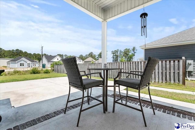 view of patio with fence and a residential view