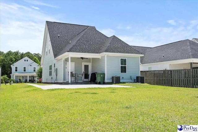 back of property with a ceiling fan, central AC, and a shingled roof