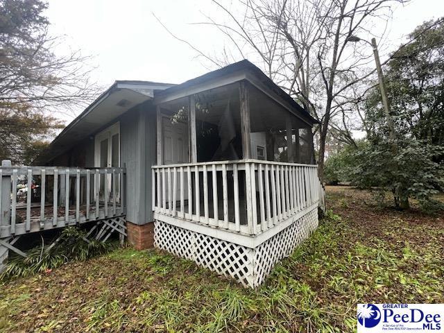 view of home's exterior with a sunroom