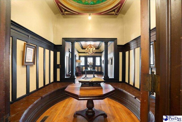 foyer featuring crown molding, a chandelier, and a high ceiling