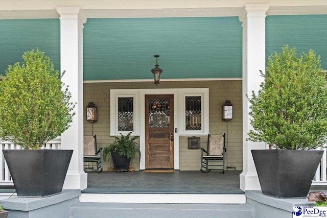 view of exterior entry with covered porch