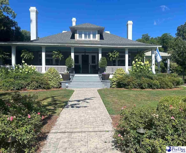 view of front of house with a front lawn and a porch