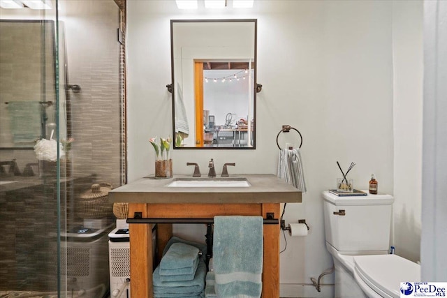 bathroom featuring an enclosed shower, vanity, and toilet