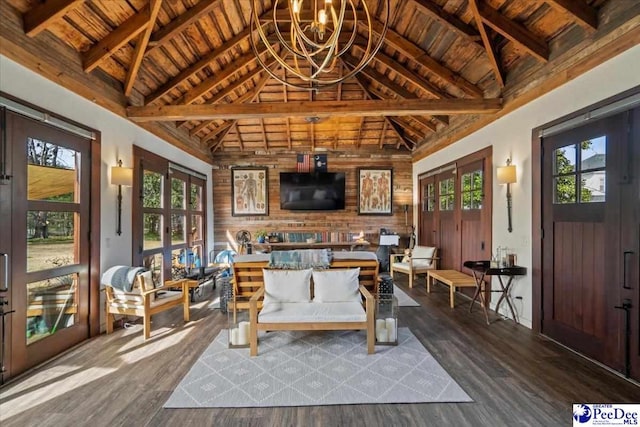 interior space with wooden ceiling, a healthy amount of sunlight, and vaulted ceiling with beams