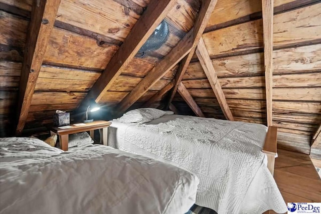 bedroom with vaulted ceiling and hardwood / wood-style floors