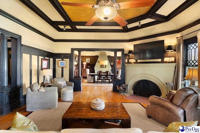 living room with coffered ceiling, light hardwood / wood-style floors, decorative columns, and beam ceiling