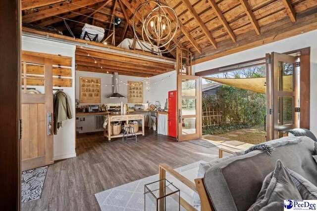 living room featuring lofted ceiling with beams, hardwood / wood-style flooring, wooden ceiling, and a chandelier