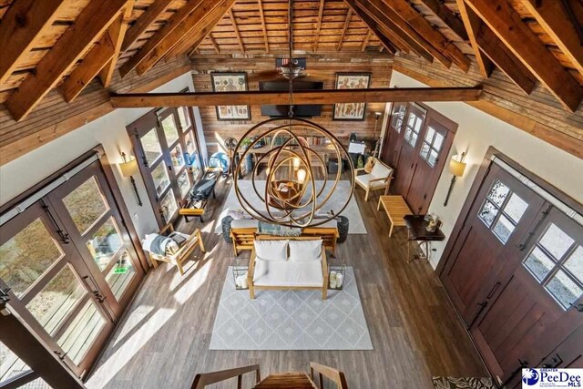 entrance foyer featuring wood-type flooring, plenty of natural light, and high vaulted ceiling