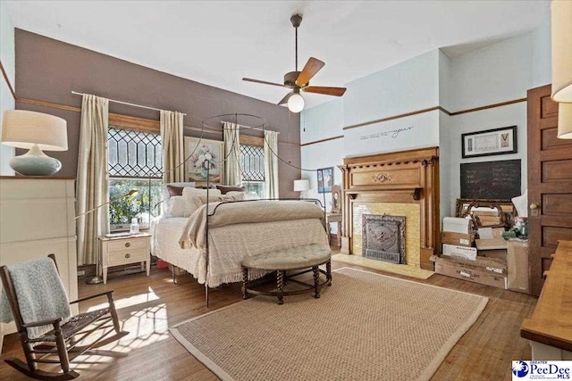 bedroom with a high ceiling and hardwood / wood-style floors