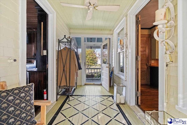 doorway to outside featuring ceiling fan, ornamental molding, and light hardwood / wood-style flooring