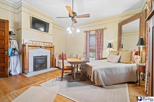 bedroom featuring ceiling fan and light hardwood / wood-style flooring