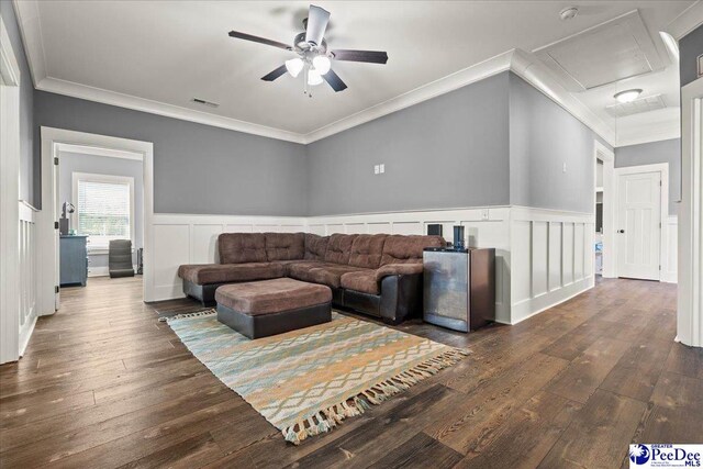 living area featuring visible vents, crown molding, hardwood / wood-style floors, attic access, and a ceiling fan