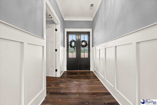 doorway with wainscoting, ornamental molding, french doors, visible vents, and dark wood-style floors