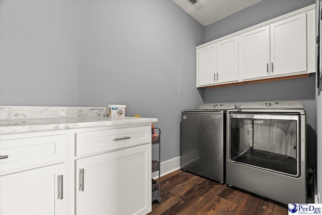 laundry room with baseboards, washer and clothes dryer, cabinet space, and dark wood-style flooring