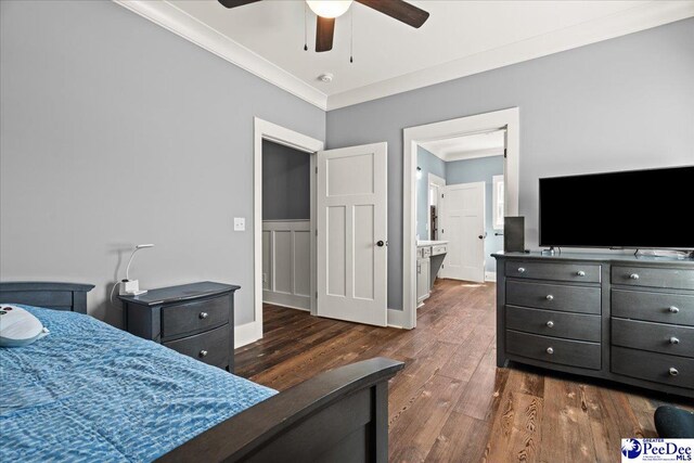 bedroom featuring dark wood-type flooring, ornamental molding, and ceiling fan