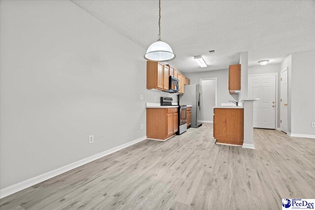 2125-D Sanderling Dr, Florence, SC 29505 - kitchen with light wood-style flooring, stainless steel appliances, brown cabinetry, a textured ceiling, and baseboards
