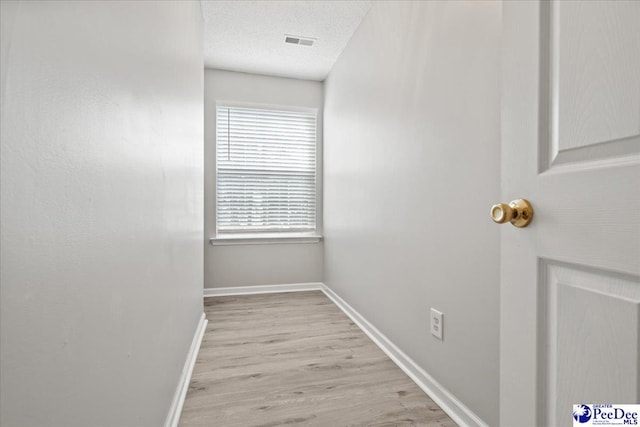 2125-D Sanderling Dr, Florence, SC 29505 - corridor with wood finished floors, visible vents, baseboards, and a textured ceiling