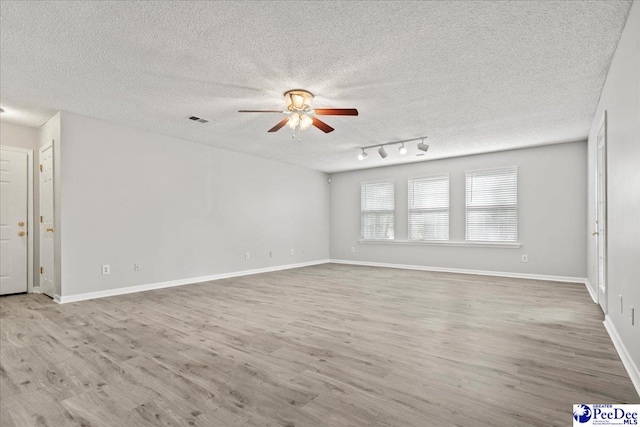 2125-D Sanderling Dr, Florence, SC 29505 - unfurnished living room featuring wood finished floors, a textured ceiling, visible vents, baseboards, and ceiling fan