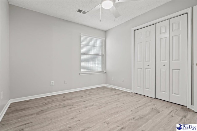 2125-D Sanderling Dr, Florence, SC 29505 - unfurnished bedroom featuring a textured ceiling, baseboards, visible vents, and wood finished floors