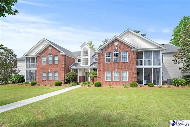 2125-D Sanderling Dr, Florence, SC 29505 - view of front facade with a sunroom, brick siding, and a front lawn