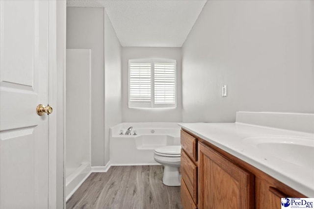 2125-D Sanderling Dr, Florence, SC 29505 - bathroom featuring a garden tub, toilet, wood finished floors, baseboards, and vanity