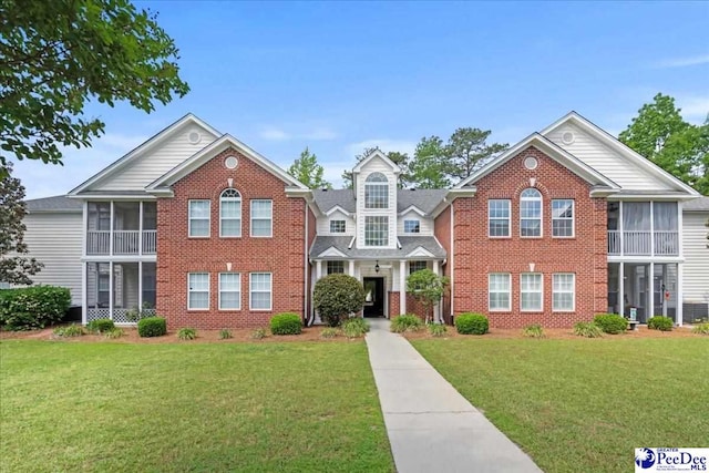 2125-D Sanderling Dr, Florence, SC 29505 - traditional-style home with a sunroom, brick siding, and a front lawn