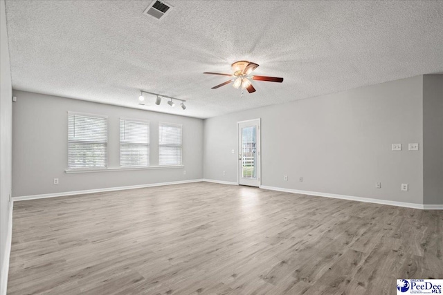 2125-D Sanderling Dr, Florence, SC 29505 - unfurnished room featuring a textured ceiling, baseboards, ceiling fan, visible vents, and wood finished floors