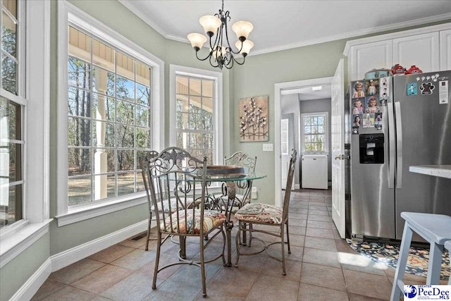 dining area featuring a chandelier, crown molding, and baseboards