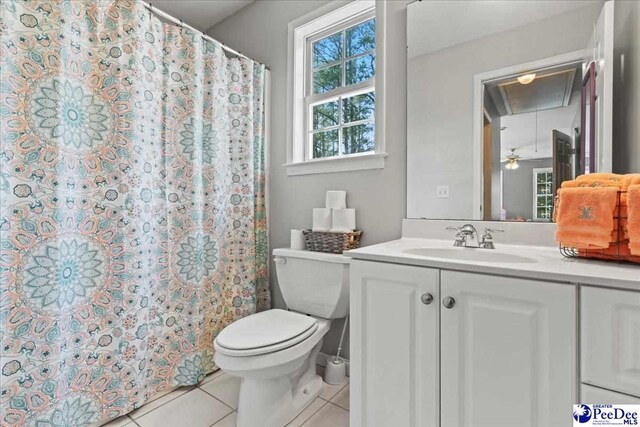 full bathroom with tile patterned flooring, a shower with shower curtain, toilet, and vanity