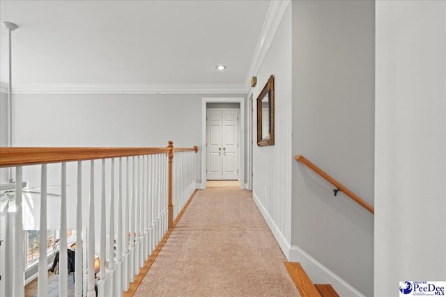 corridor with an upstairs landing, recessed lighting, crown molding, baseboards, and light colored carpet