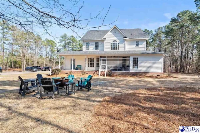 rear view of property with a sunroom