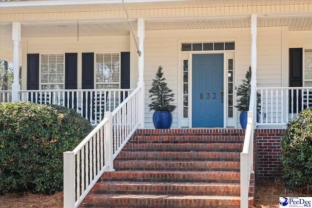 doorway to property with a porch