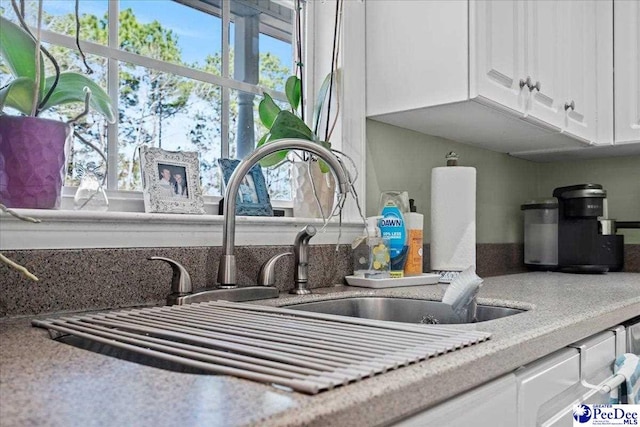 room details featuring white cabinets and light countertops