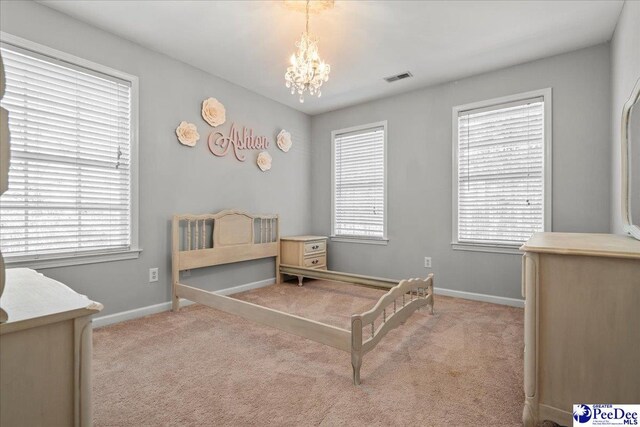 bedroom featuring multiple windows, carpet, and visible vents