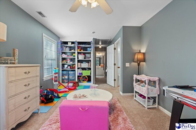 recreation room featuring carpet flooring, visible vents, a ceiling fan, and baseboards