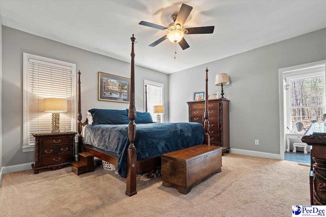 bedroom with light carpet, a ceiling fan, and baseboards