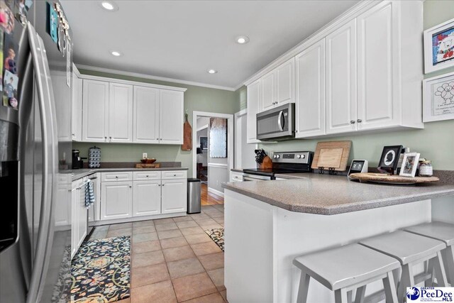 kitchen featuring white cabinetry, a peninsula, and appliances with stainless steel finishes