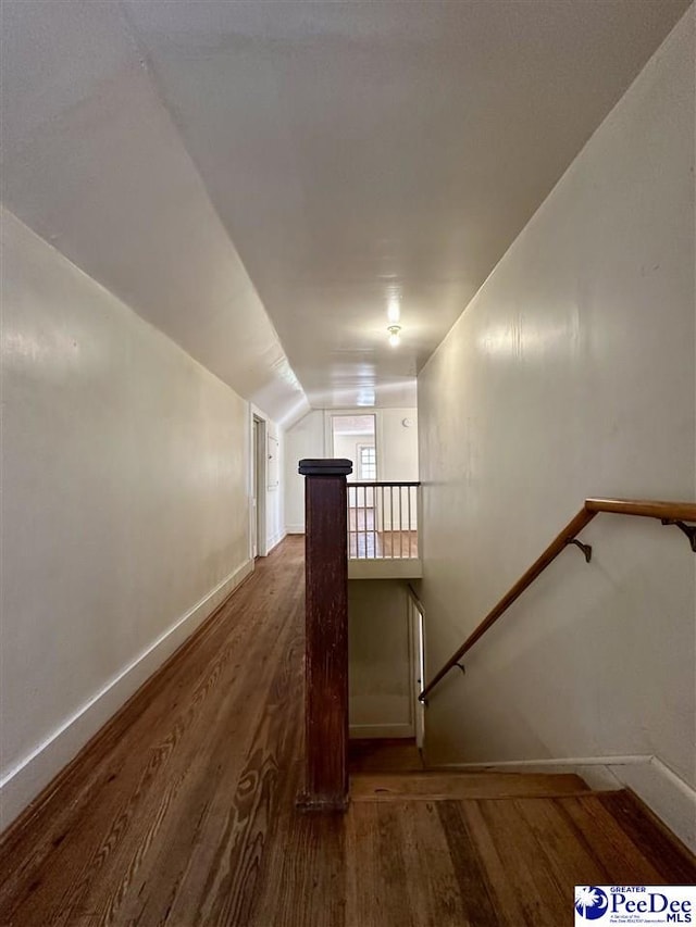 stairway with hardwood / wood-style flooring and vaulted ceiling