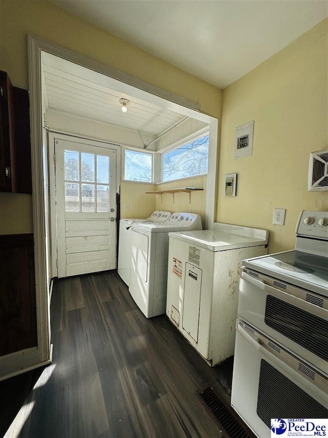 clothes washing area with separate washer and dryer and dark wood-type flooring