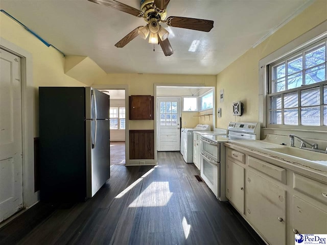 kitchen featuring sink, white cabinetry, stainless steel refrigerator, dark hardwood / wood-style floors, and range with two ovens