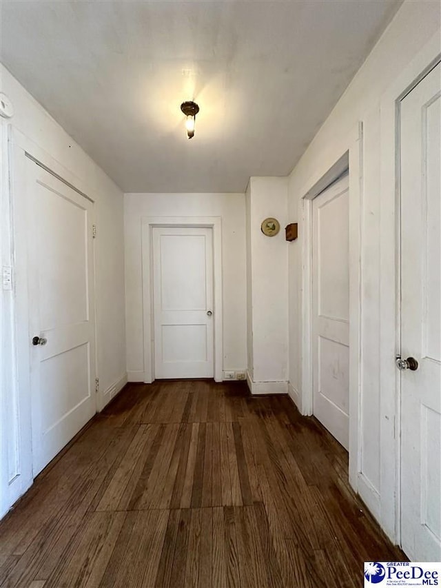 hallway with dark hardwood / wood-style floors