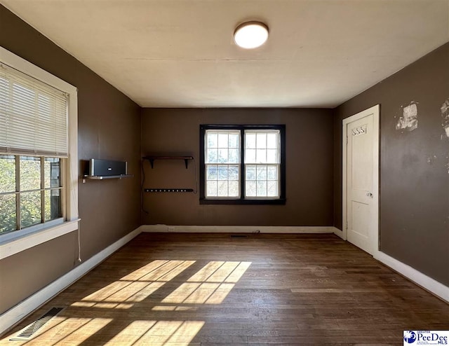 spare room with dark hardwood / wood-style floors