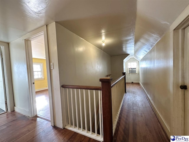 corridor featuring dark hardwood / wood-style flooring, cooling unit, and lofted ceiling